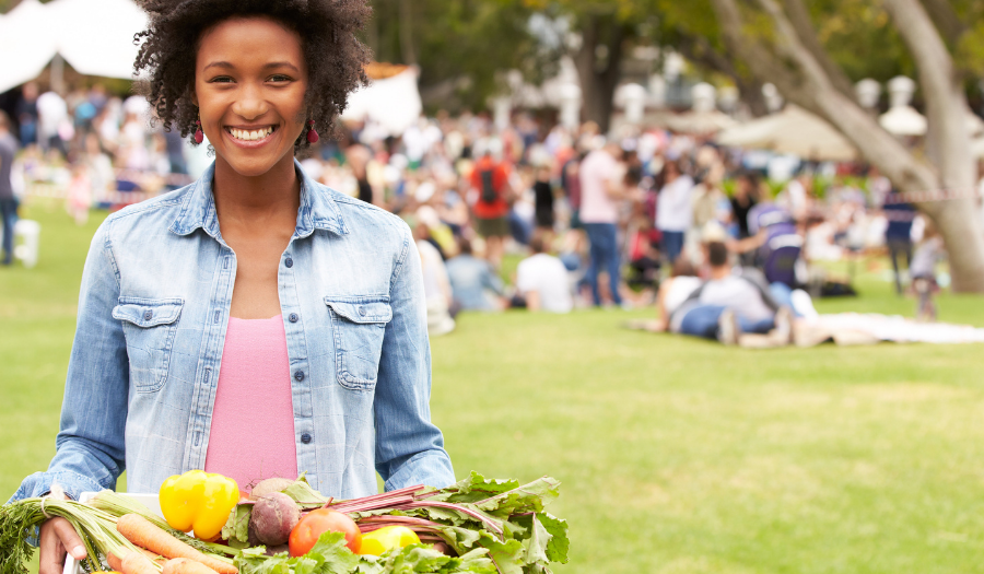 Woman holding basket of vegetables